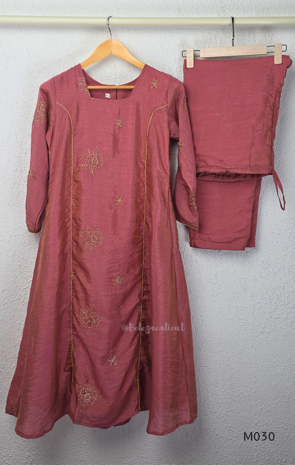 Dusty rose 2-piece kurti set with gold floral motifs, gold piping detail, matching bottom, 3/4 sleeves, and relaxed flared fit.