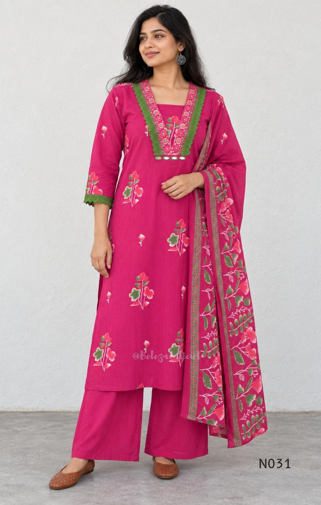 Pink cotton three-piece churidar set with floral print, green lace and embroidered neckline details, plain wide palazzo pants and a floral-border dupatta.
