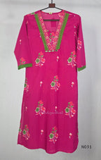 Pink cotton three-piece churidar set with floral print, green lace and embroidered neckline details, plain wide palazzo pants and a floral-border dupatta. - view 3