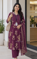 Grape cotton churidar set with cream floral stem print, stitched mirror-style yoke work, matching printed dupatta, plain bottom, and 3/4 sleeves.