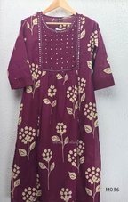 Grape cotton churidar set with cream floral stem print, stitched mirror-style yoke work, matching printed dupatta, plain bottom, and 3/4 sleeves.