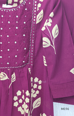Grape cotton churidar set with cream floral stem print, stitched mirror-style yoke work, matching printed dupatta, plain bottom, and 3/4 sleeves.
