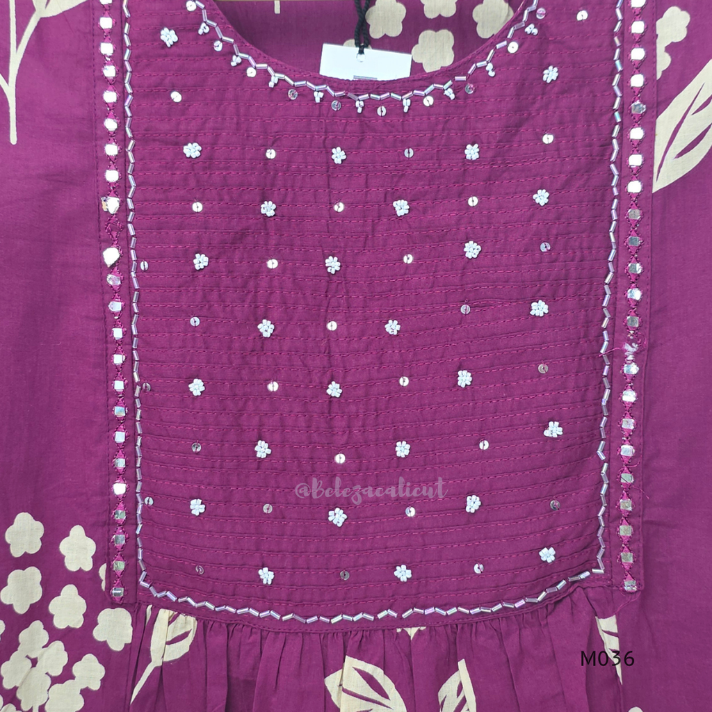 Grape cotton churidar set with cream floral stem print, stitched mirror-style yoke work, matching printed dupatta, plain bottom, and 3/4 sleeves.
