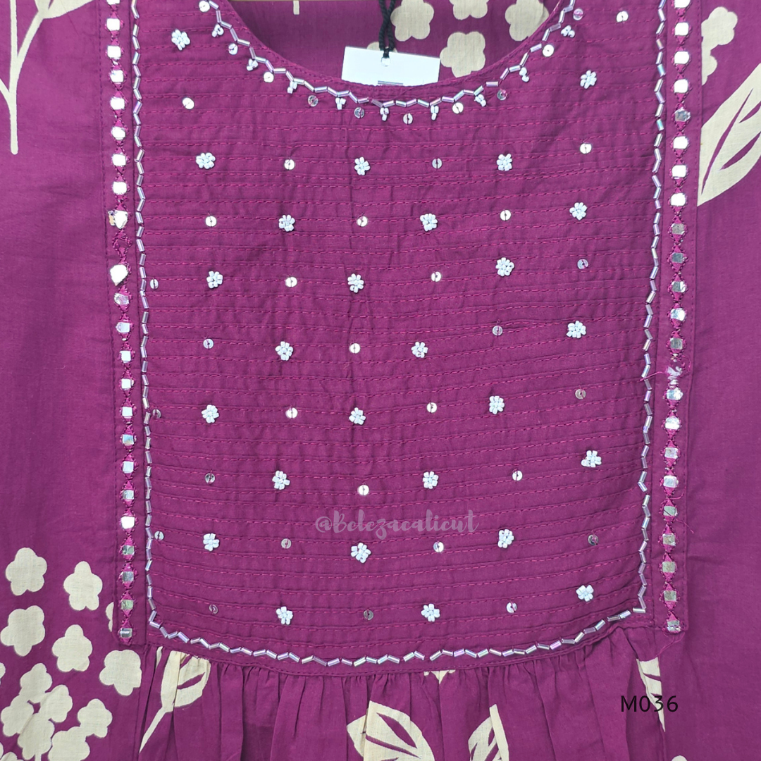 Grape cotton churidar set with cream floral stem print, stitched mirror-style yoke work, matching printed dupatta, plain bottom, and 3/4 sleeves.