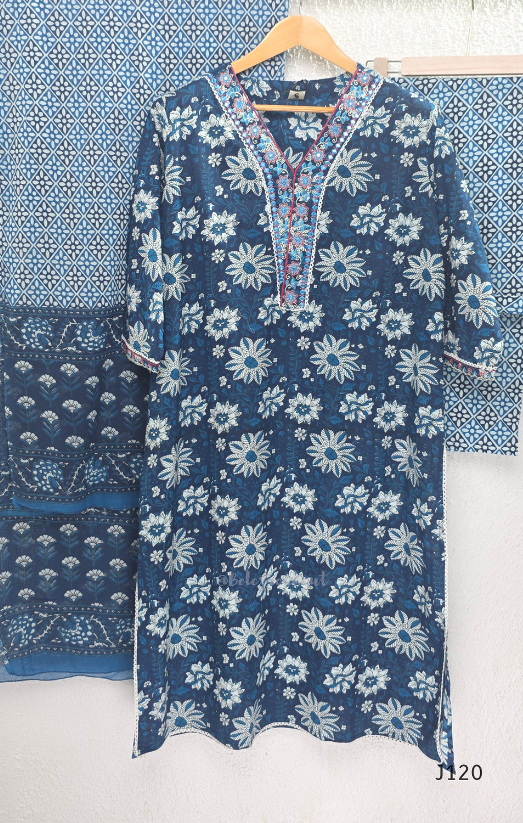 Indigo blue Jaipur cotton 3-piece churidar set with white floral print, embroidered V-neck, printed dupatta and matching printed bottom.