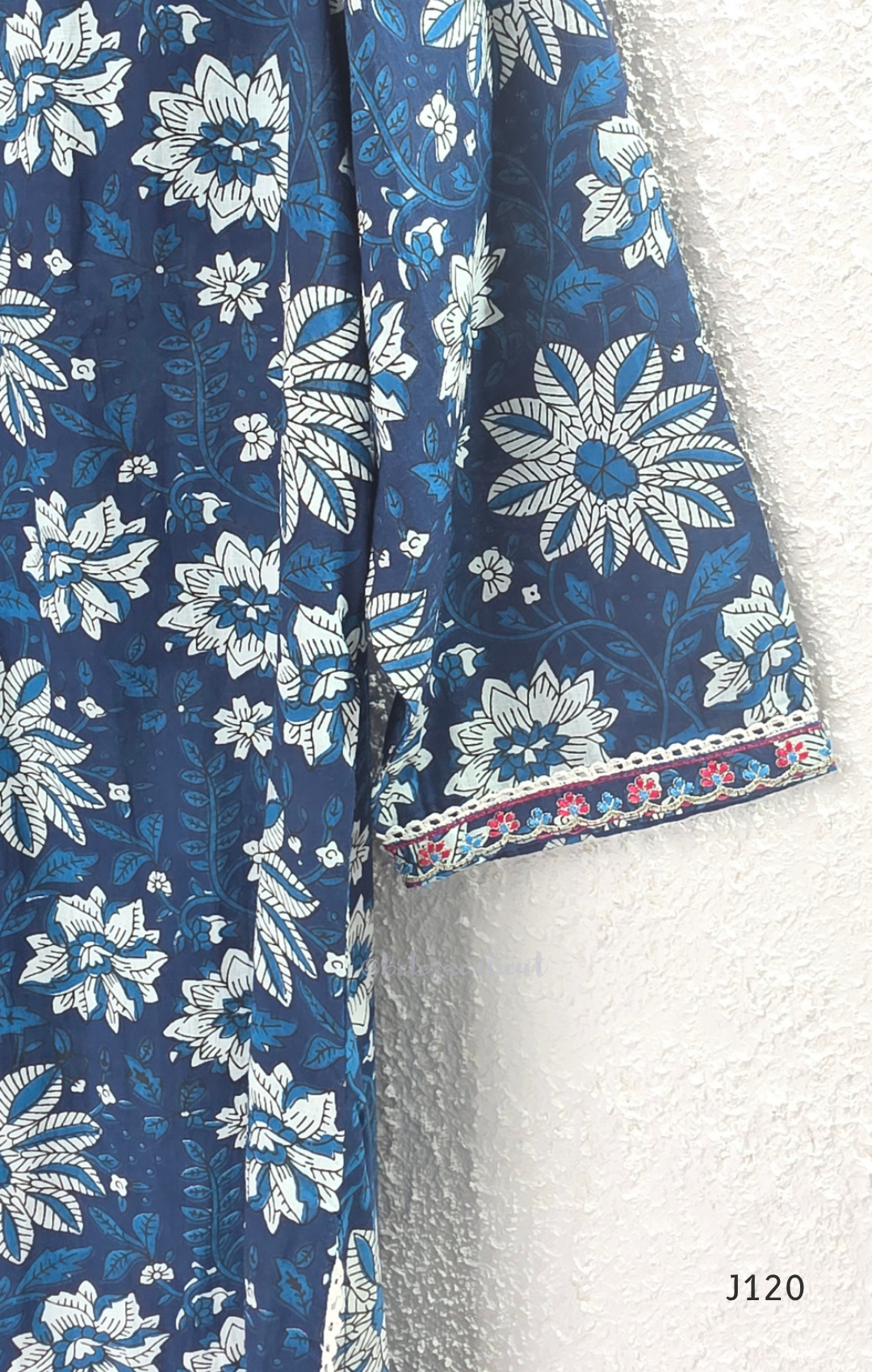 Indigo blue Jaipur cotton 3-piece churidar set with white floral print, embroidered V-neck, printed dupatta and matching printed bottom.