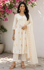 Ivory Cora Cotton churidar set with pink and yellow floral embroidery, matching straight pants and embroidered dupatta.