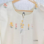Ivory Cora Cotton churidar set with pink and yellow floral embroidery, matching straight pants and embroidered dupatta.