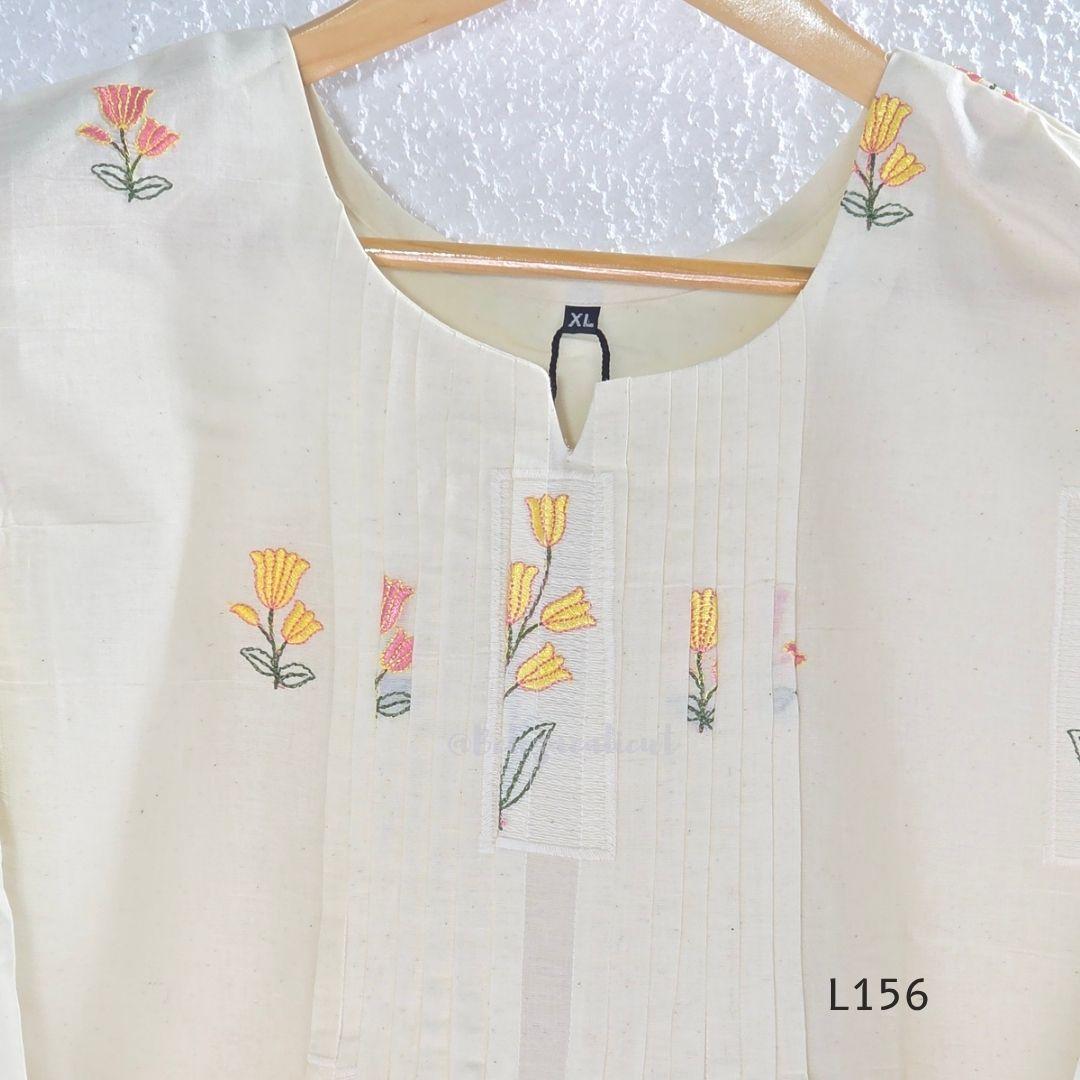 Ivory Cora Cotton churidar set with pink and yellow floral embroidery, matching straight pants and embroidered dupatta.