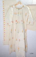 Ivory Cora Cotton churidar set with pink and yellow floral embroidery, matching straight pants and embroidered dupatta.