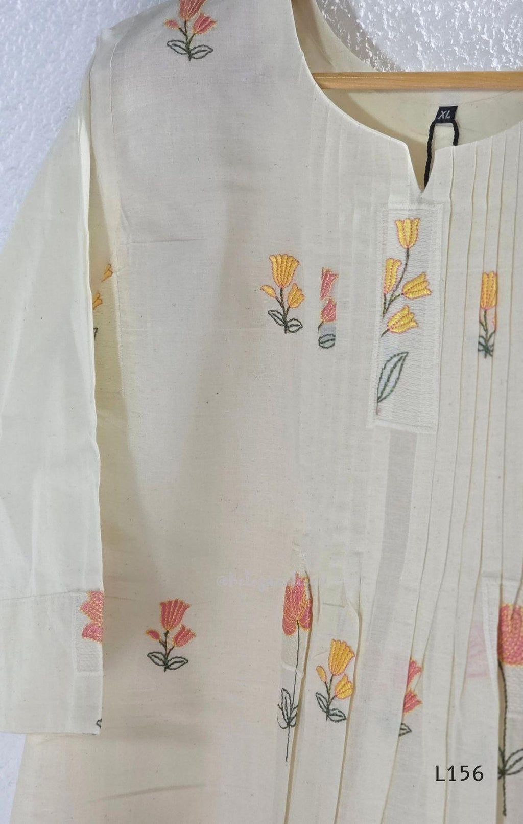 Ivory Cora Cotton churidar set with pink and yellow floral embroidery, matching straight pants and embroidered dupatta.