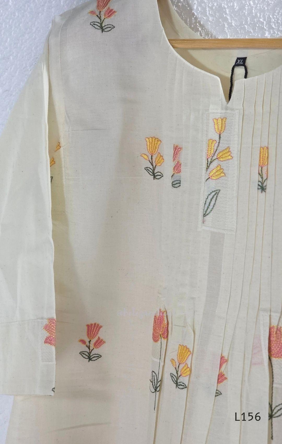 Ivory Cora Cotton churidar set with pink and yellow floral embroidery, matching straight pants and embroidered dupatta.