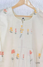 Ivory Cora Cotton churidar set with pink and yellow floral embroidery, matching straight pants and embroidered dupatta.