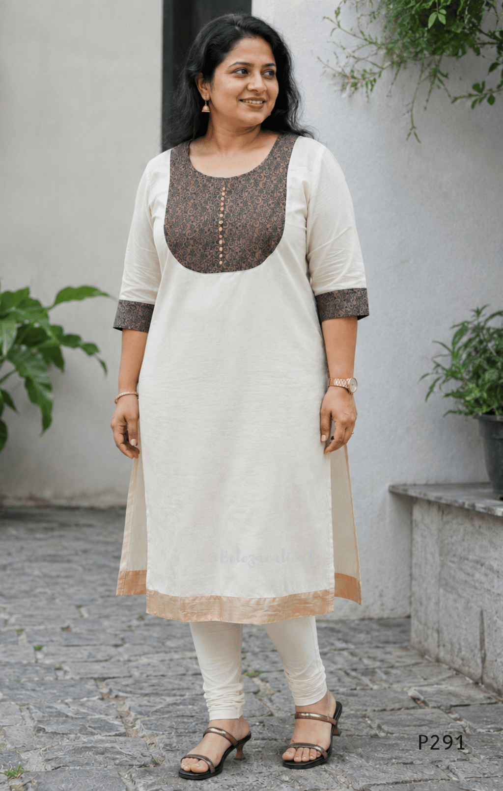 Ivory cotton women’s ethnic top with brown printed yoke, small button detail, printed sleeve cuffs, and straight fit.
