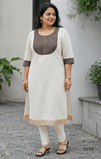 Ivory cotton women’s ethnic top with brown printed yoke, small button detail, printed sleeve cuffs, and straight fit.