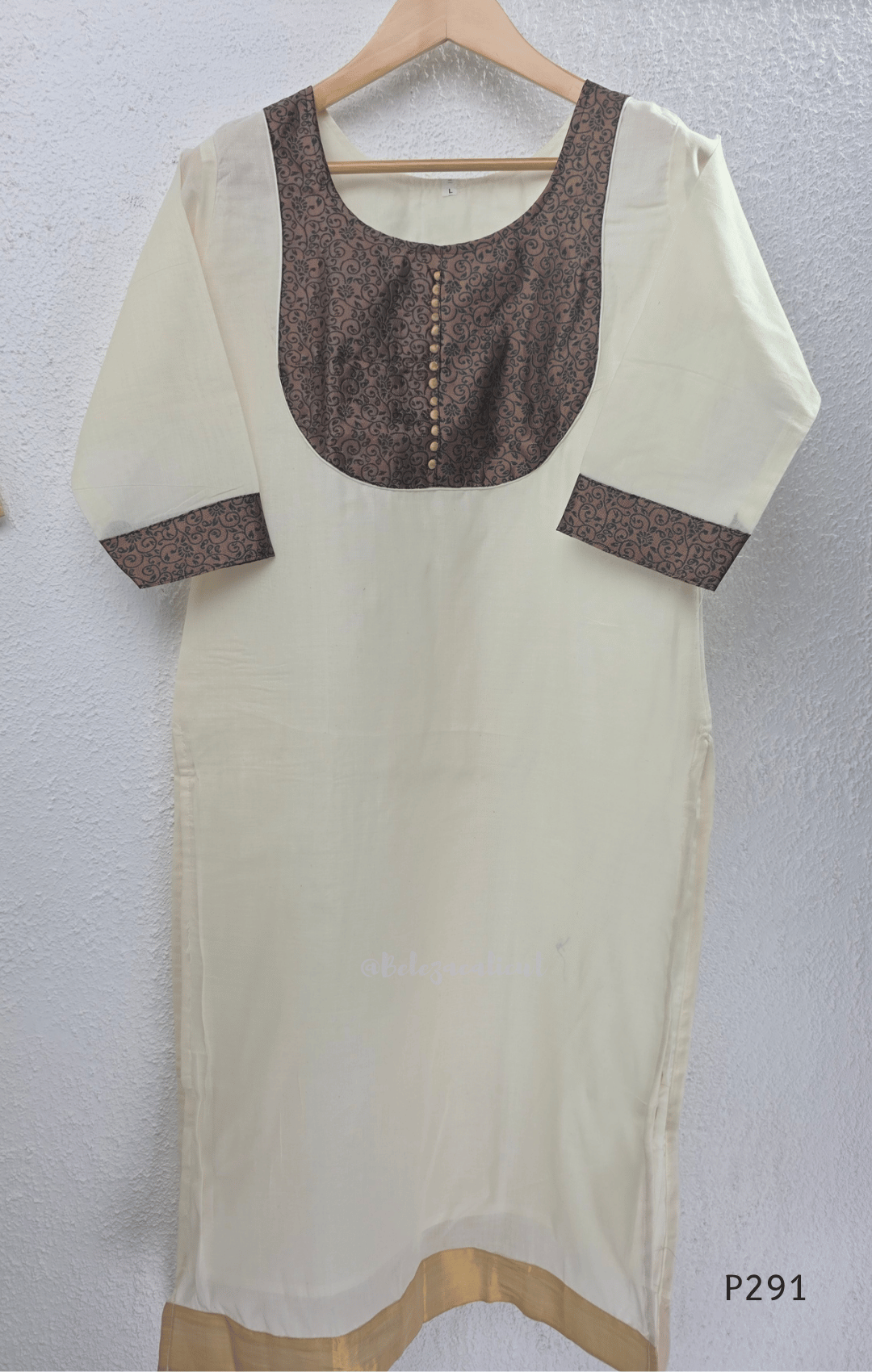 Ivory cotton women’s ethnic top with brown printed yoke, small button detail, printed sleeve cuffs, and straight fit.
