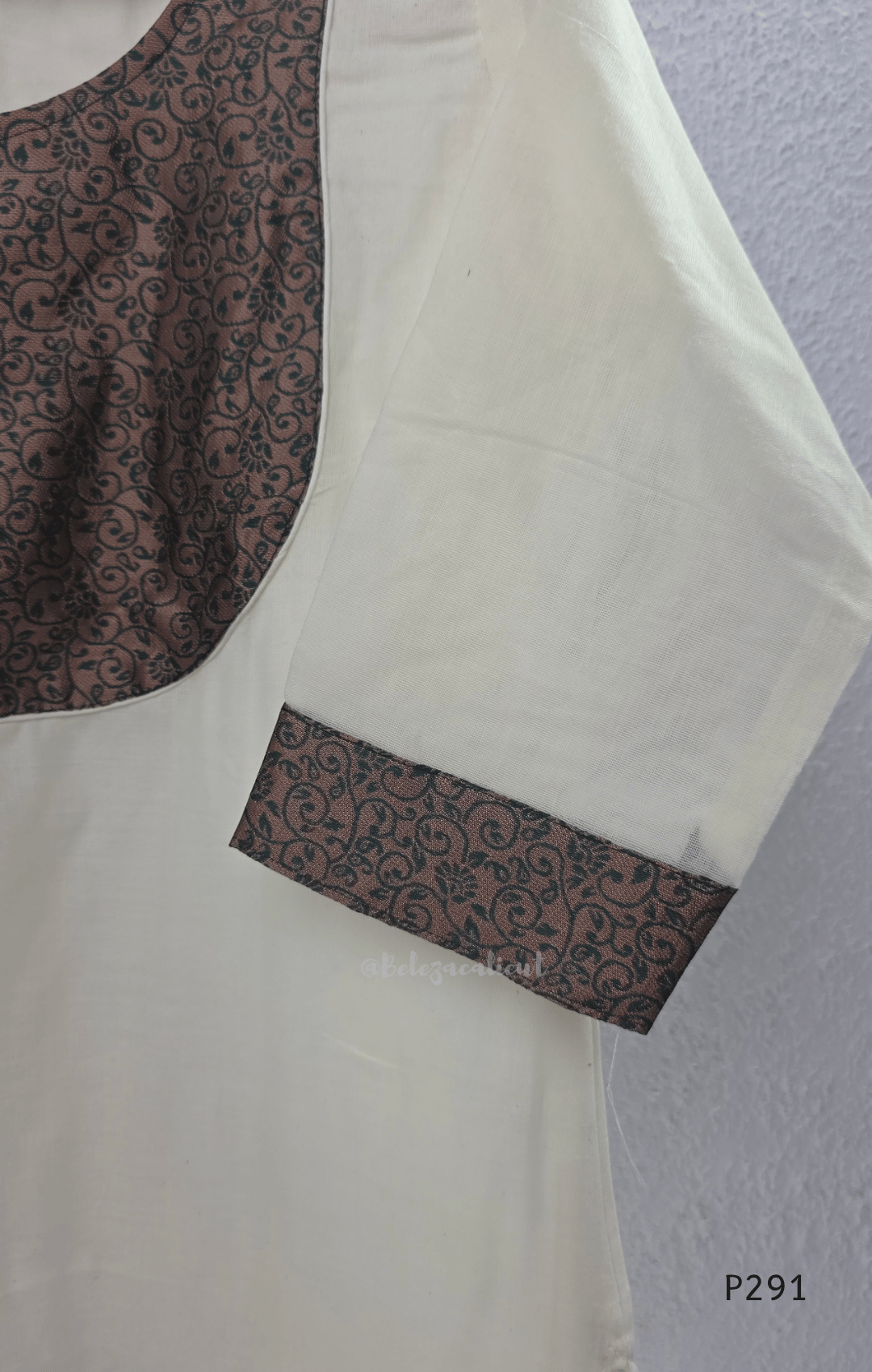 Ivory cotton women’s ethnic top with brown printed yoke, small button detail, printed sleeve cuffs, and straight fit.