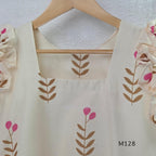 Ivory cotton 2-piece co-ord set with pink and brown botanical motifs, ruffled sleeveless shoulders and vertically striped matching bottom.