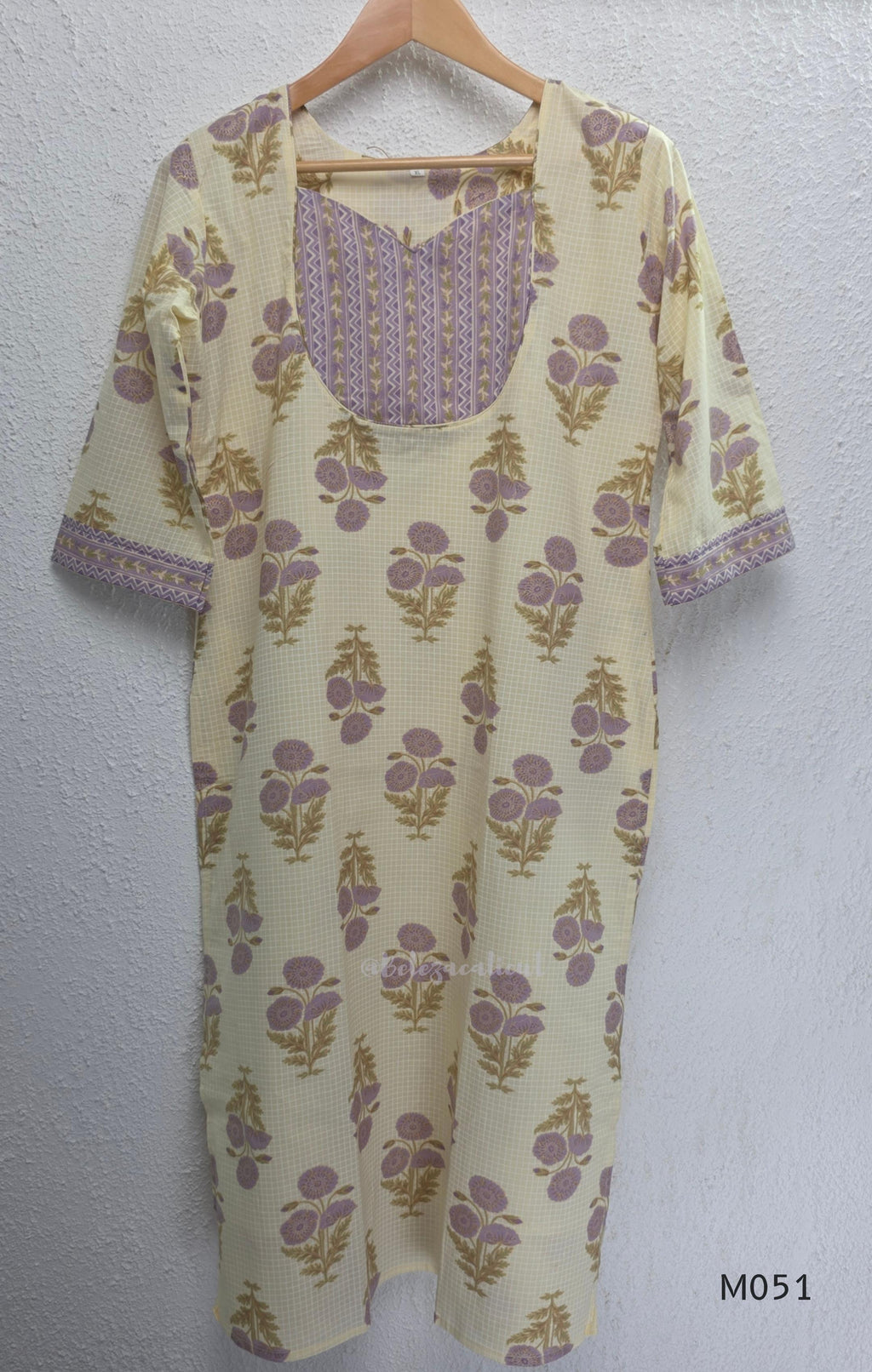 Ivory cotton 3-piece churidar set with dusty lavender floral motifs, contrast printed yoke, matching striped bottom and floral bordered dupatta.