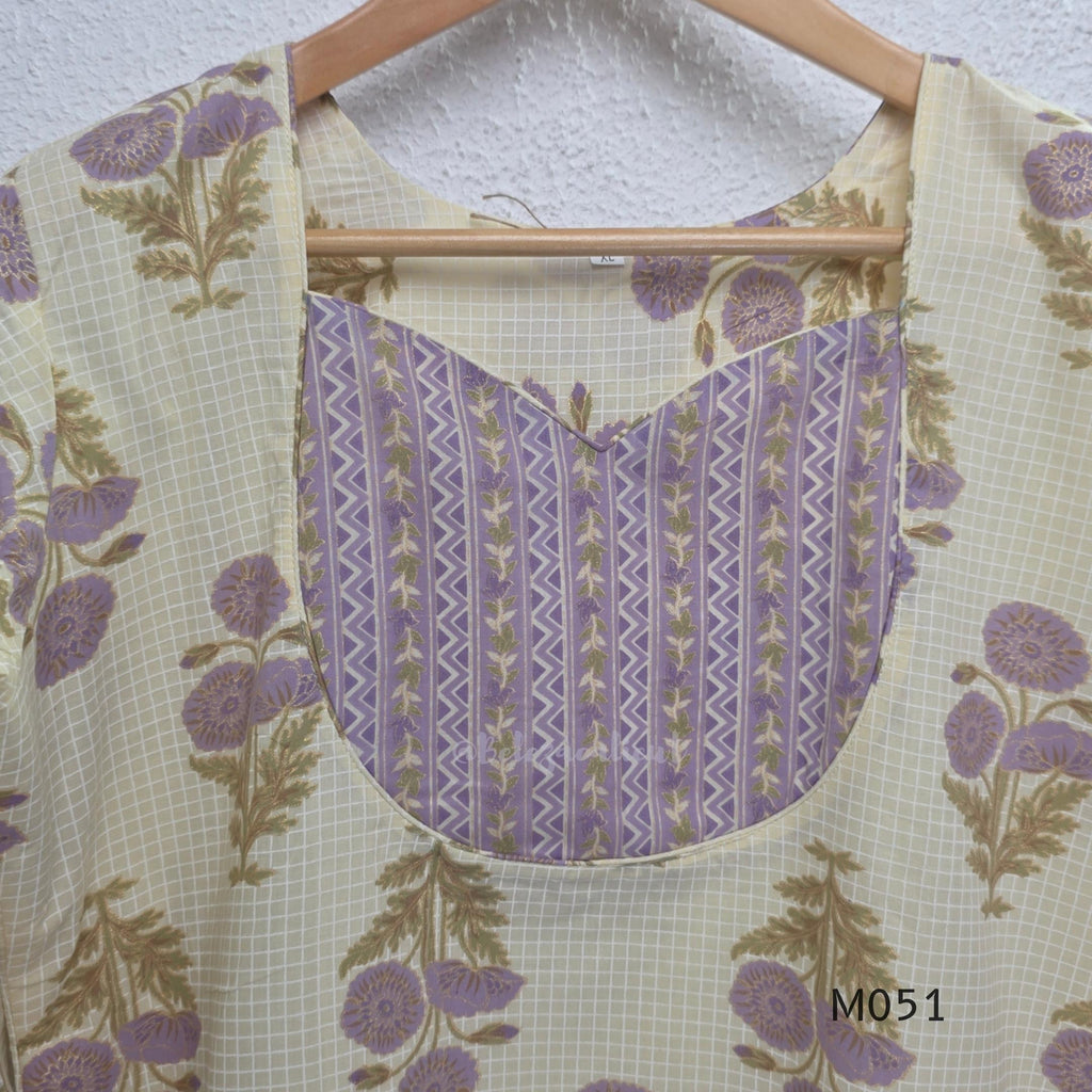 Ivory cotton 3-piece churidar set with dusty lavender floral motifs, contrast printed yoke, matching striped bottom and floral bordered dupatta.