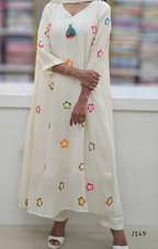 Woman wearing a cream-colored kurta with floral embroidery in a store setting