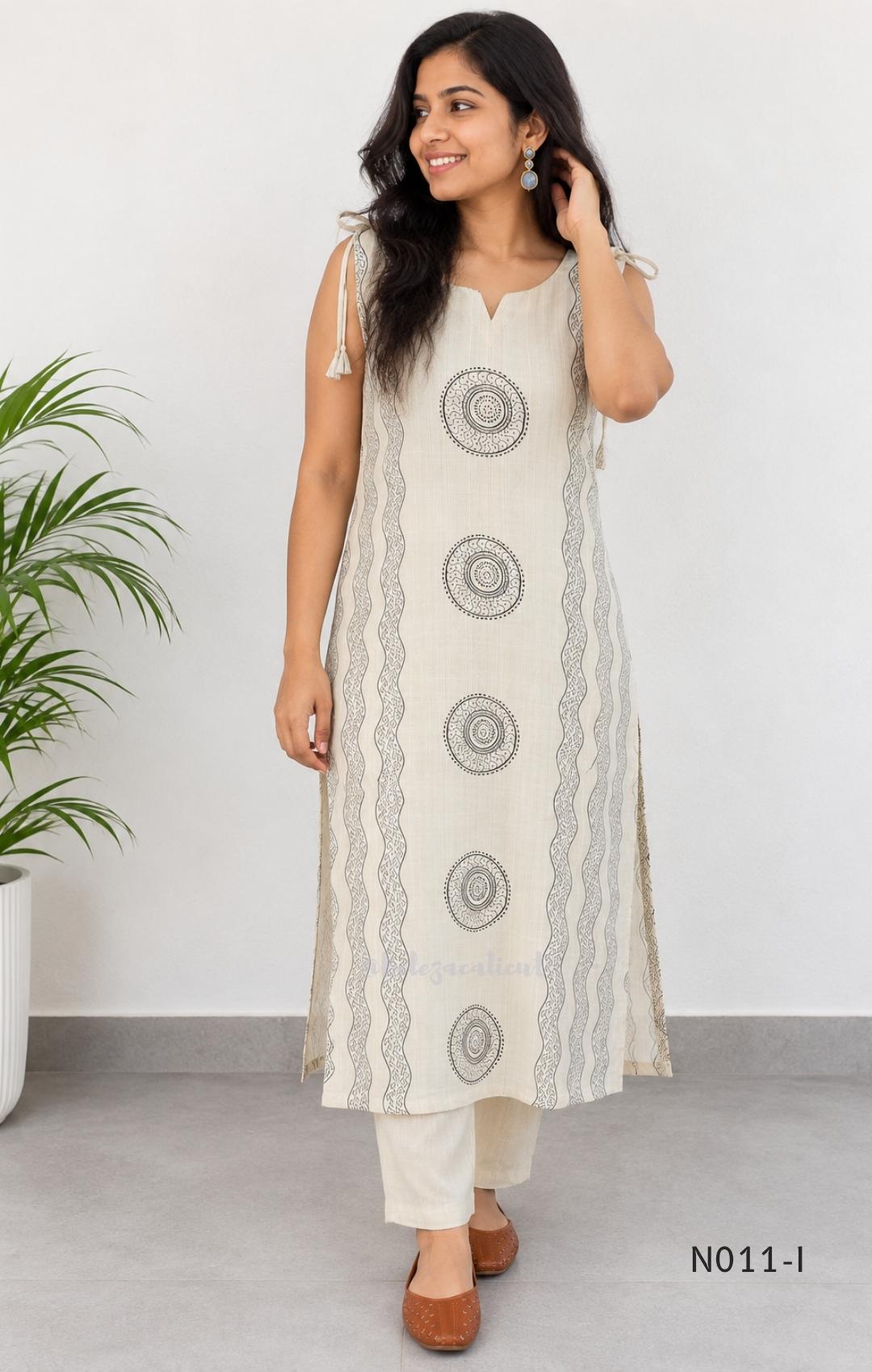 Ivory Vertigan silk co-ord set with dark circular motifs, wavy side-border print and matching straight pants.