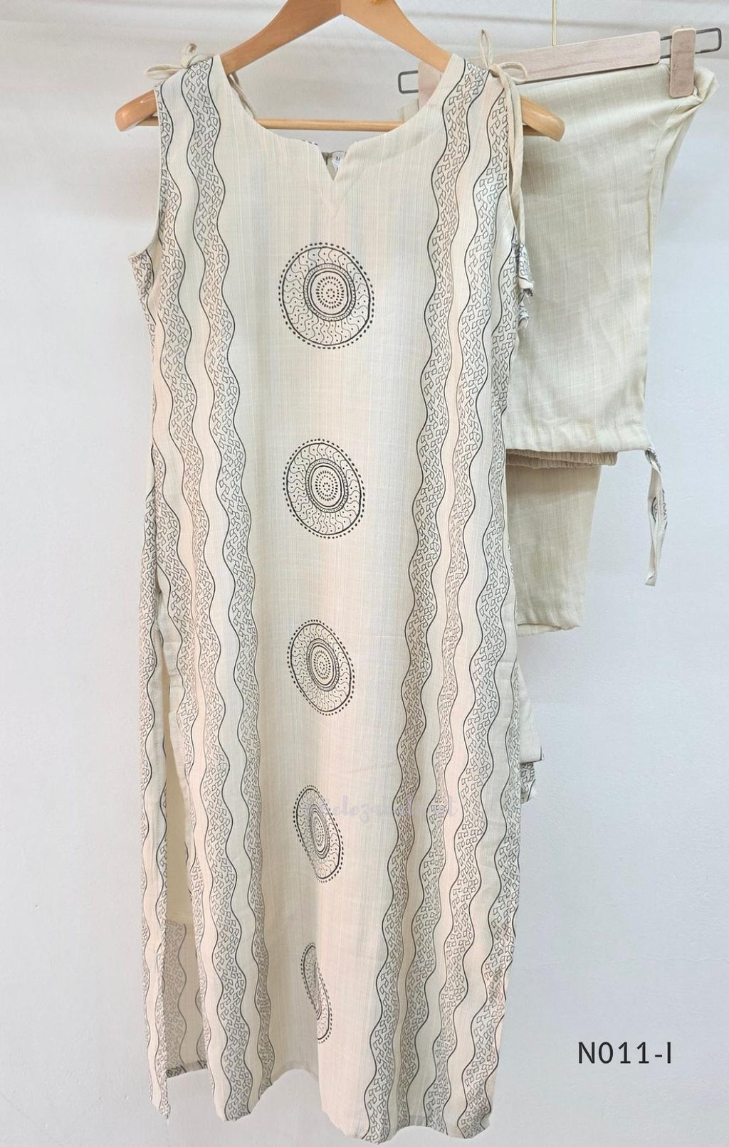 Ivory Vertigan silk co-ord set with dark circular motifs, wavy side-border print and matching straight pants.
