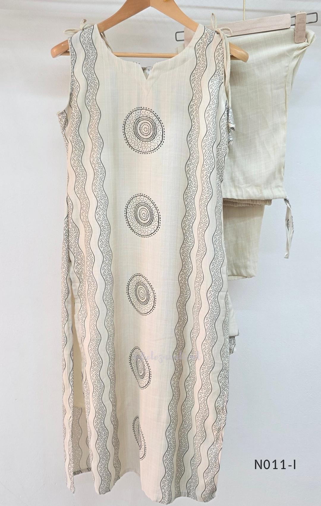 Ivory Vertigan silk co-ord set with dark circular motifs, wavy side-border print and matching straight pants.