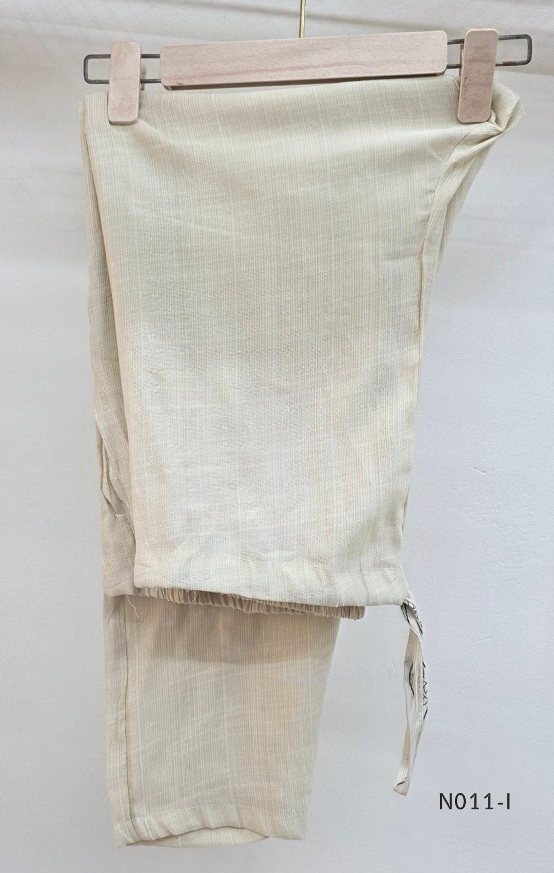 Ivory Vertigan silk co-ord set with dark circular motifs, wavy side-border print and matching straight pants.
