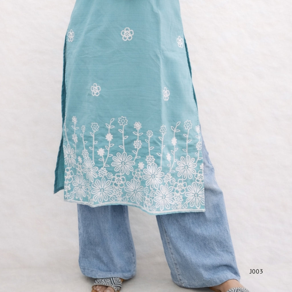 Light blue embroidered top and pants on a white background