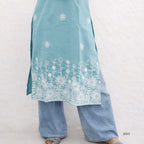 Light blue embroidered top and pants on a white background