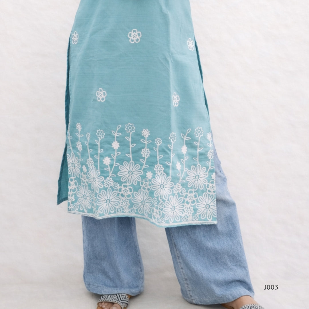 Light blue embroidered top and pants on a white background