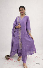 Woman wearing a purple traditional outfit with embroidery on a white background