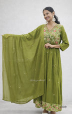 Woman wearing a green traditional outfit with a matching dupatta on a white background
