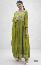 Woman wearing a green embroidered dress on a white background