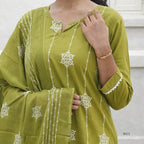 Green embroidered traditional outfit with white patterns on a neutral background