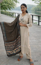 Woman holding a patterned scarf by a lake