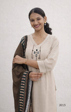 Woman wearing a beige kurta with a brown dupatta against a white background
