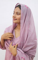 Woman wearing a light purple scarf with floral patterns on a white background