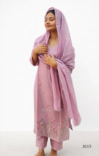 Woman wearing a pink traditional outfit with a matching dupatta on a white background