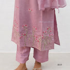 Pink embroidered outfit with floral patterns on a white background