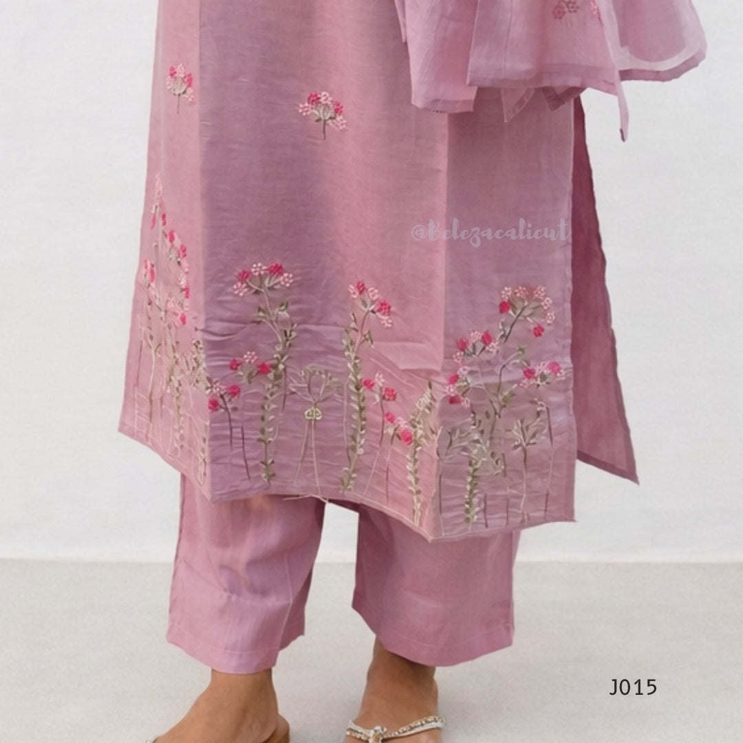 Pink embroidered outfit with floral patterns on a white background