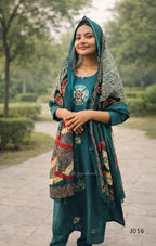 Woman wearing a teal outfit with a patterned shawl in an outdoor setting