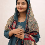Woman wearing a patterned scarf on a plain background