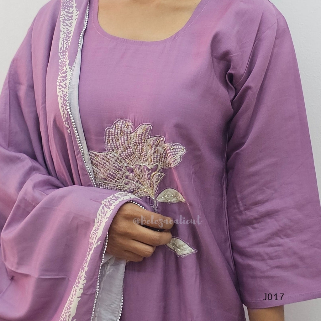 Purple outfit with floral embroidery on a plain background