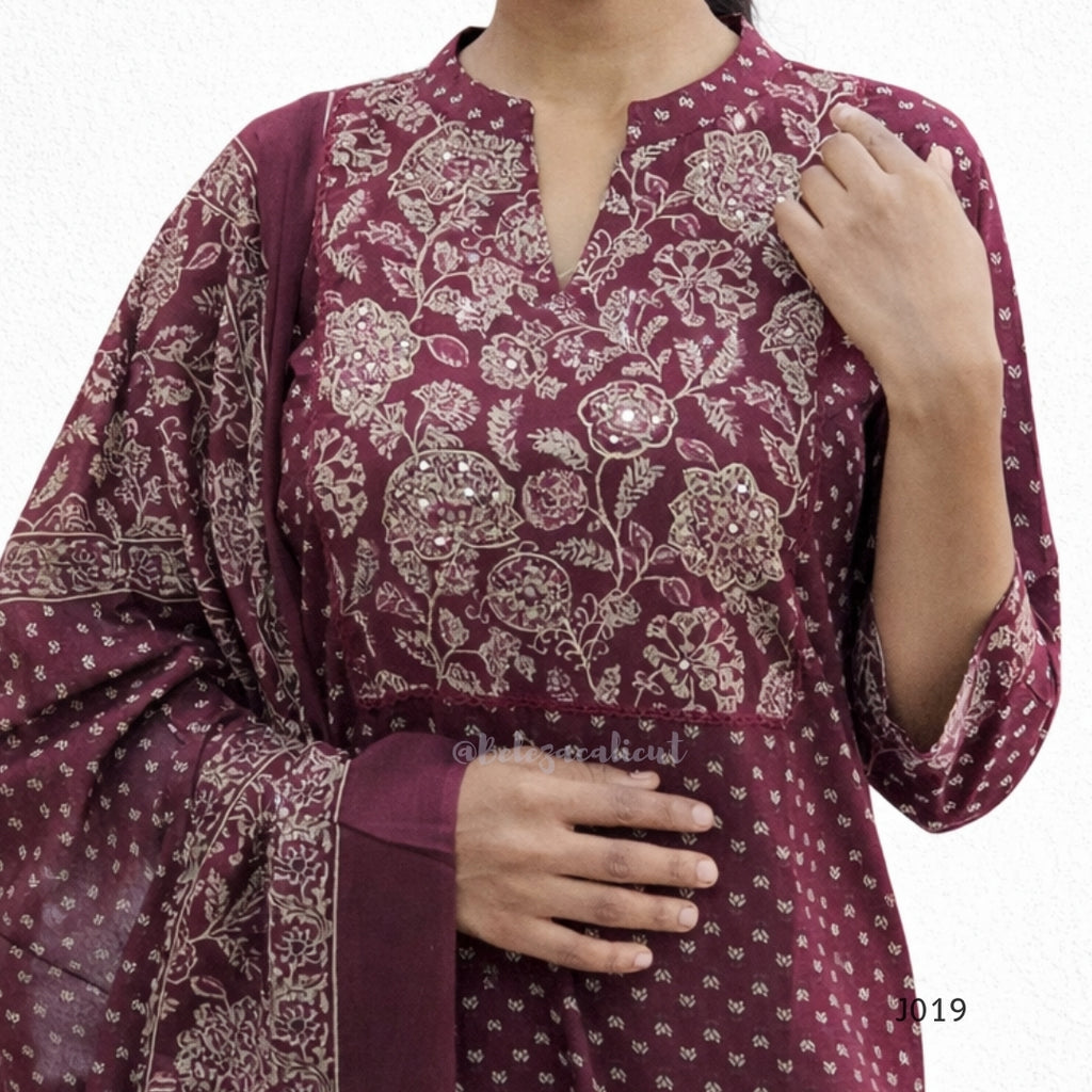 Maroon traditional outfit with floral patterns on a white background