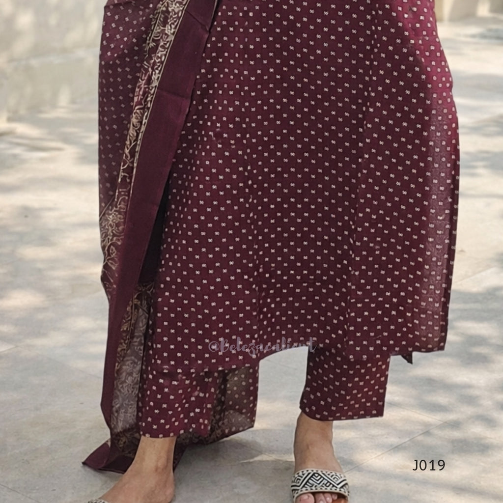 Maroon dress with white pattern on a light background