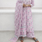 Person wearing a pink floral outfit with a matching dupatta on a white background