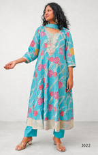 Woman wearing a turquoise floral dress on a white background