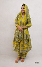 Woman wearing a yellow traditional outfit with a matching dupatta on a white background